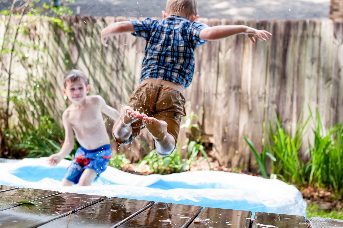 boys jumping in pool